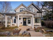 Charming home featuring a covered porch, decorative details, and a well-maintained front yard at 3182 5Th St, Boulder, CO 80304