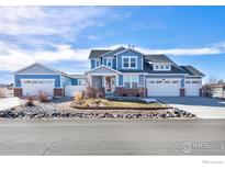 Charming two-story home featuring a well-manicured front yard, attached garage, and inviting curb appeal at 3385 Birch Rd, Longmont, CO 80504