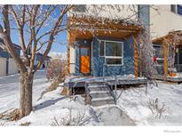 Charming blue home featuring a cozy front porch and natural wood accents at 4653 14Th St, Boulder, CO 80304