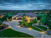 Stunning home featuring a landscaped front yard and a circular driveway leading to a spacious three-car garage at 4822 Bandera Pl, Parker, CO 80134