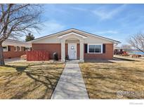 Charming single-story brick home with inviting front porch and well-maintained lawn at 5425 County Road 32 # 13, Mead, CO 80504