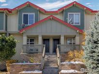 Charming townhome showcasing stone accents and a cozy front porch at 6343 E Ohio Ave, Denver, CO 80224