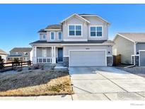 Charming two-story home with covered porch, attached two-car garage, and well-maintained landscaping at 16722 Chilton Dr, Mead, CO 80542