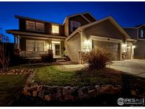 Charming two-story home at night with a well-maintained front yard at 1931 Rannoch Dr, Longmont, CO 80504