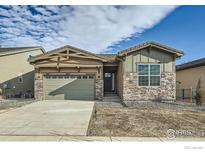 Charming single-story home featuring stone accents, a well-manicured lawn, and an attached two-car garage at 2978 Newfound Lake Rd, Berthoud, CO 80513