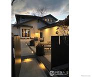 Inviting home exterior with a front patio, warm lighting, and a stylish modern design at 4803 Briar Ridge Ct, Boulder, CO 80301