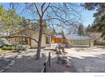 Unique home showcasing xeriscaping, metal roofing, modern garage door, and attractive curb appeal at 503 Kalmia Ave, Boulder, CO 80304