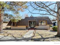 Charming home featuring a unique roofline and a walkway leading to the front door at 58 Curtis Ct, Broomfield, CO 80020