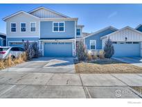 Charming two-story home featuring a well-maintained front yard and a two-car garage at 651 Stonebridge Dr, Longmont, CO 80503