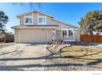 Charming two-story home featuring a brick facade, attached garage, and well-maintained front yard at 11091 Wolff Way, Westminster, CO 80031