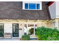 Charming townhome featuring white brick, black trim, and a lovely landscaped front at 1251 S Monaco Pkwy, Denver, CO 80224