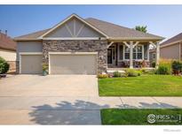 Charming single-Gathering home with stone accents, three-car garage, and a well-manicured lawn at 13943 W 87Th Ln, Arvada, CO 80005