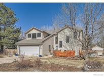 Charming two-story home with attached two-car garage and manicured front yard at 1555 Sumac Ave, Boulder, CO 80304