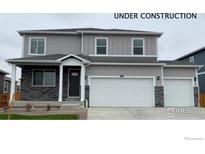 New construction gray two-story home with a three car garage and covered front porch at 1854 Westport Ave, Berthoud, CO 80513