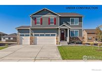 Inviting two-story home showcasing a three-car garage, well-manicured lawn, and charming curb appeal at 1884 Westport Ave, Berthoud, CO 80513