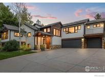 Inviting two-story home with a two-car garage and inviting covered entry under a blue, pink, and orange sky at 2545 Tamarack Ave, Boulder, CO 80304