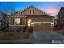 Inviting single-Gathering home with a two-car garage and manicured front yard, showcasing its charming curb appeal at 29 Sun Up Cir, Erie, CO 80516