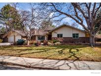 Charming single-story ranch with brick accents, mature trees, and well-maintained lawn at 330 Hopi Pl, Boulder, CO 80303