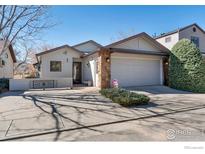 Charming home featuring stone accents, a two-car garage, and well-maintained landscaping at 607 Cressman Ct, Golden, CO 80403