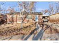 Charming brick single-story home with a carport and a cozy front porch, perfect for relaxed outdoor living at 6167 Newland St, Arvada, CO 80003