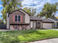 Charming home with a well-maintained lawn, stone accents, and a two-car attached garage in a lovely neighborhood at 720 W Dahlia St, Louisville, CO 80027