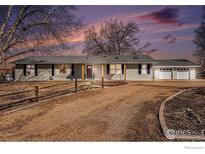 Charming single-story home with a gravel driveway and a detached two-car garage at 9752 Sierra Vista Rd, Longmont, CO 80504