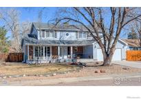 Charming two-story home featuring a welcoming front porch and well-maintained landscaping at 1109 E 7Th Ave Cir, Broomfield, CO 80020