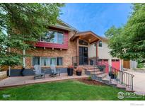 Charming two-story home with a brick facade, cozy porch, and well-manicured lawn at 2850 Emerson Ave, Boulder, CO 80305