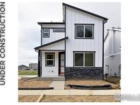 Modern two-story home features black trim, white siding, and a stylish red front door at 343 Pyramid Peak St, Berthoud, CO 80513