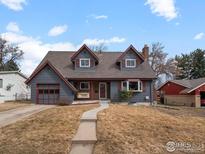 Charming two-story home featuring a cozy front porch swing and well-maintained landscaping at 5854 Urban Ct, Arvada, CO 80004