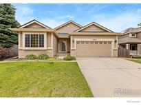 Charming single-Gathering home featuring a well-manicured lawn and an attached two-car garage at 5870 Scenic Ave, Firestone, CO 80504