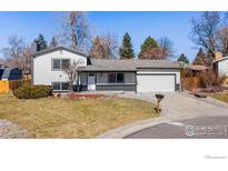 Charming two-story home features a manicured front yard and an attached two-car garage at 6115 W 84Th Way, Arvada, CO 80003