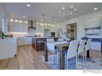 Bright, spacious kitchen boasts modern appliances, large island, and stylish light fixtures at 960 Saint Andrews Ln, Louisville, CO 80027