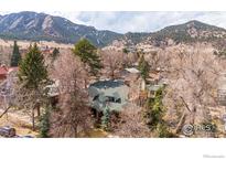 Stunning home nestled amongst mature trees with mountain views in the background at 981 11Th St, Boulder, CO 80302