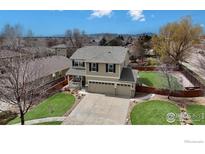 Charming two-story home with a well-maintained lawn, mature trees, and an attached two car garage at 14396 Corrine Ct, Broomfield, CO 80023