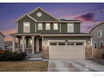 Charming two-story home with a well-manicured lawn, stone accents, and a spacious two-car garage at 16317 Saint Paul St, Thornton, CO 80602