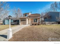 Charming home featuring a well-manicured front yard and attached garage at 1858 Sumner St, Longmont, CO 80501