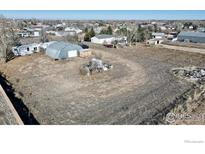 Expansive lot featuring a metal shop building and ample space for various uses at 339 Lilac Cir, Lochbuie, CO 80603