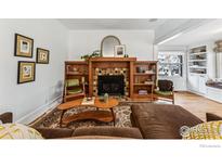 Inviting living room features a cozy fireplace and built-in shelves, perfect for relaxing at 721 Monroe St, Denver, CO 80206