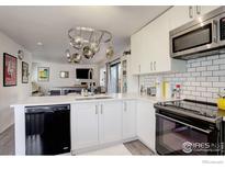 Modern kitchen featuring white cabinets, stainless steel appliances, and a subway tile backsplash at 1031 Portland Pl # 4, Boulder, CO 80304