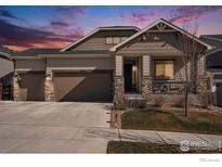 Charming home featuring a three-car garage, stone accents, neutral siding and covered porch, perfect for enjoying outdoor living at 12596 Eagle River Rd, Firestone, CO 80504