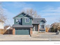 Charming two-story home with a well-maintained yard and attached garage on a sunny day at 1454 Alpine St, Longmont, CO 80504