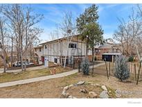 Charming multi-level home featuring a private fenced yard and an attached one-car garage at 159 Judson St, Longmont, CO 80501