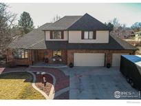 Charming two-story home with brick and vinyl siding, attached garage and mature landscaping at 2525 22Nd Dr, Longmont, CO 80503