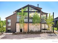 Modern home exterior showcasing large windows, stonework, and landscaping at 2586 3Rd St, Boulder, CO 80304