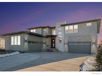 Contemporary two-story home boasts a three-car garage and mixed siding at 3564 Doubletrack Ln, Castle Rock, CO 80108