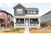 Charming gray two-story home with a welcoming front porch and manicured lawn at 408 S 2Nd Ave, Superior, CO 80027