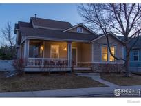 Inviting single-Gathering home featuring a cozy front porch with stone accents and well-maintained landscaping at 4315 Bella Vista Dr, Longmont, CO 80503