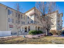 Inviting condo exterior with a well-maintained lawn, covered entrance, and stylish architectural details at 4500 Baseline Rd # 1208, Boulder, CO 80303