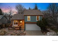 Charming two-story home with a cozy front porch and well-maintained landscaping at dusk at 520 Barberry Ave, Lafayette, CO 80026